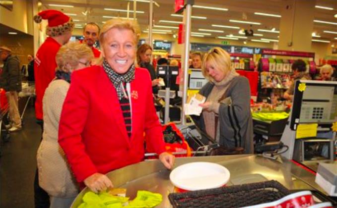 Herbert packs supermarket bags for his late mum Queenles charity in 2012